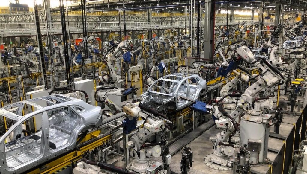 Photo of interior of Vinfast auto plant, showing many robots